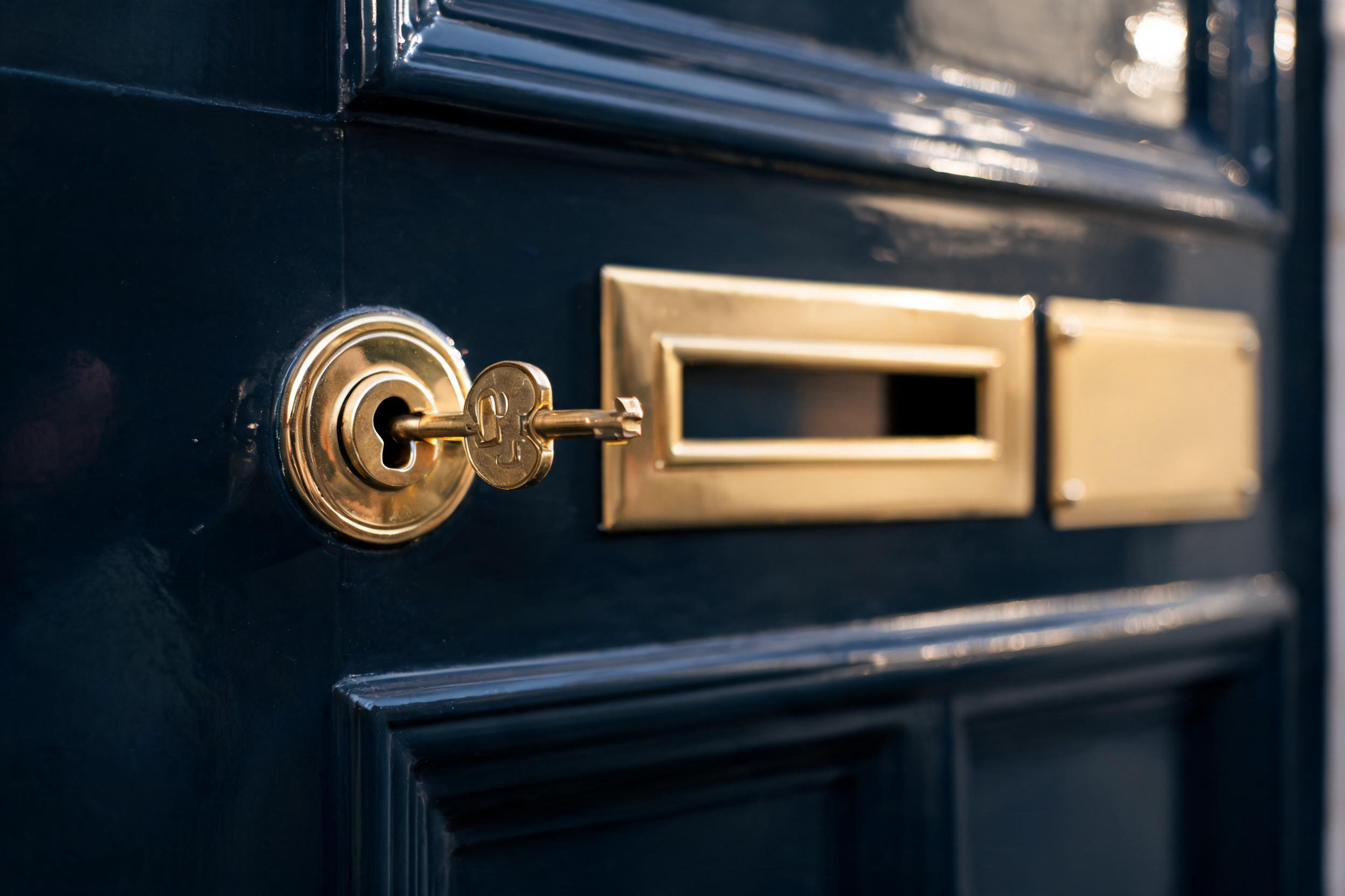 Brass key in the lock of a Regency front door